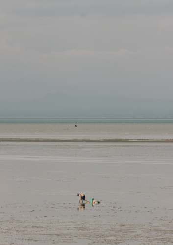 jembatan nasional suramadu 2 person walking on beach during daytime surabaya city